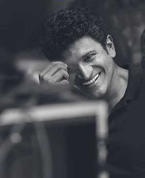 Portrait of a smiling man with curly hair in black and white, Punith Rajkumar, actor, kannada HD phone wallpaper