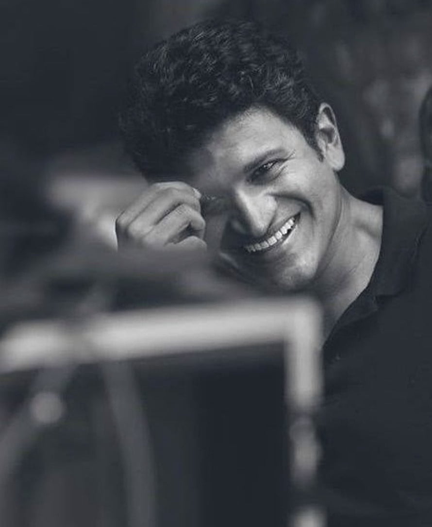 Portrait of a smiling man with curly hair in black and white, Punith Rajkumar, actor, kannada HD phone wallpaper