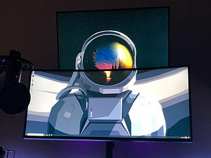Astronaut Helmet Reflection Wallpaper on Dual Stacked Monitors Setup HD wallpaper