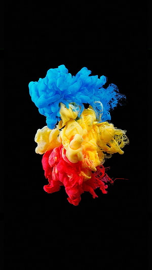 Vibrant Blue Yellow and Red Ink Swirls Diffusing in Water Against Black Background HD phone wallpaper