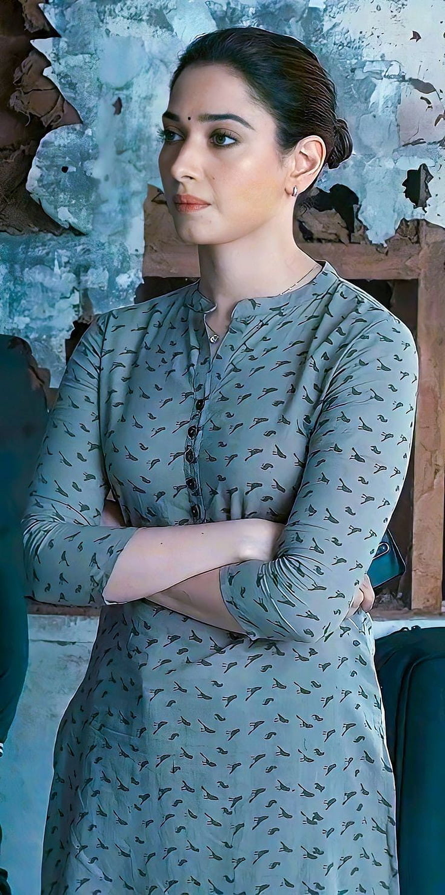Tamanna Bhatia in a grey patterned kurta with arms crossed against a weathered wall HD phone wallpaper