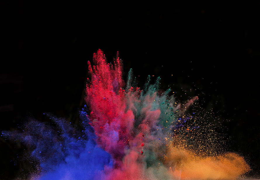 Vibrant multicolored powder explosion captured against a dark background HD wallpaper
