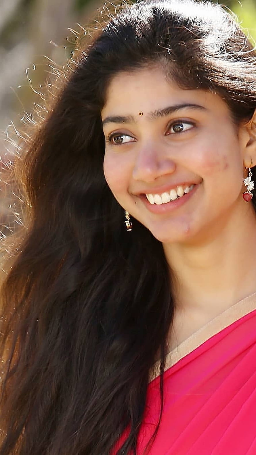 Sai Pallavi smiling portrait in pink saree with long dark hair and traditional jewelry HD phone wallpaper