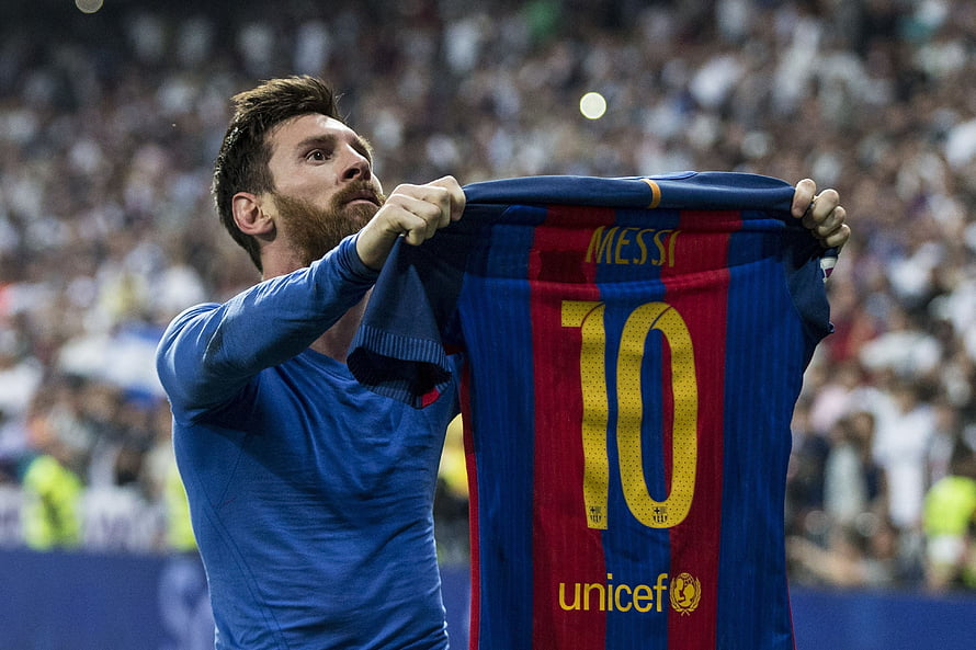 Lionel Messi holding up FC Barcelona jersey with number 10 and UNICEF logo HD wallpaper