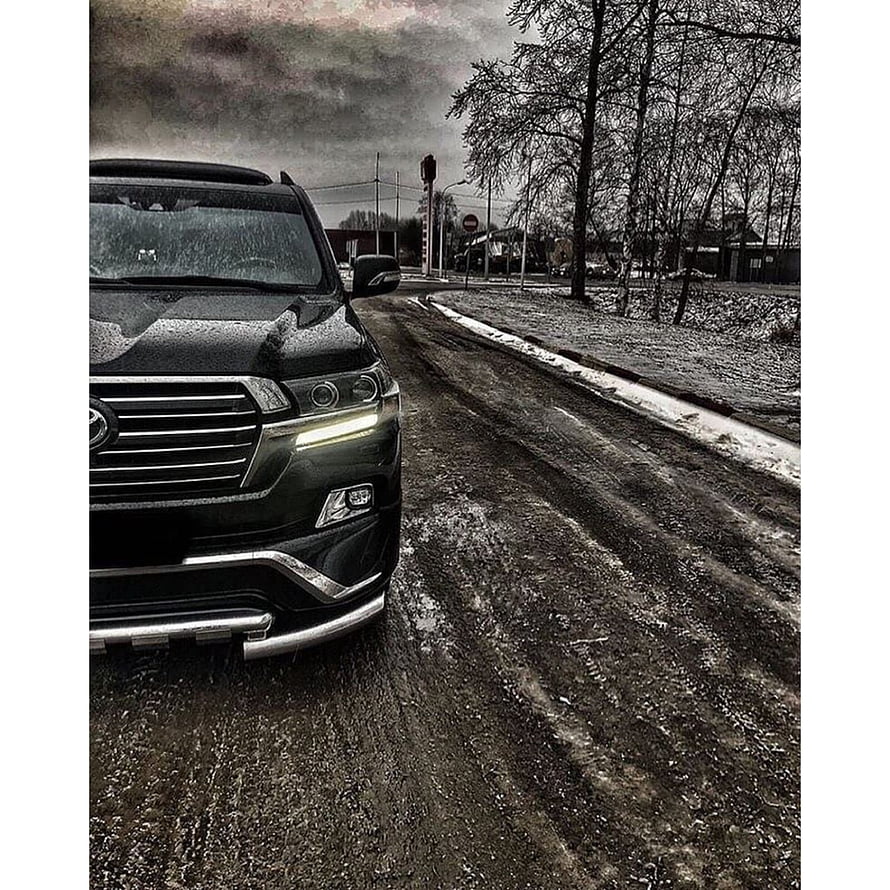 Black Toyota Land Cruiser on a Snowy Road with Dramatic Cloudy Sky HD phone wallpaper