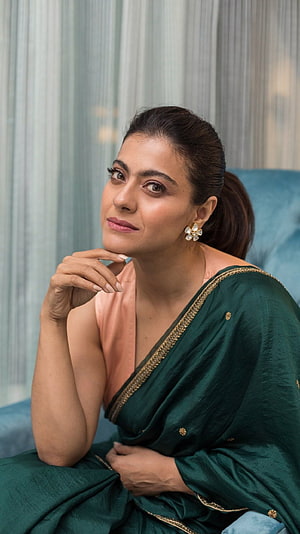 Kajol in an elegant emerald green saree with gold border and floral earrings HD phone wallpaper