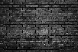 Monochrome Black Brick Wall Texture with Weathered Surface and Industrial Character HD wallpaper