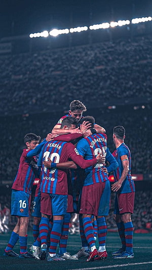 FC Barcelona players celebrating a goal in a stadium HD phone wallpaper