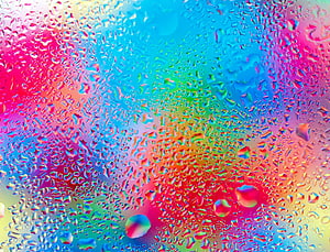 Vibrant Rainbow Water Droplets on Glass Surface with Prismatic Color Refraction HD wallpaper