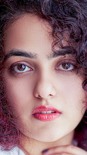 Nithya Menon Close-Up Portrait with Curly Hair and Expressive Eyes HD phone wallpaper