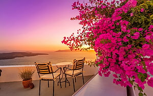 Romantic Santorini Terrace with Vibrant Bougainvillea and Aegean Sea Sunset View HD wallpaper