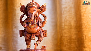 Hand-Carved Wooden Lord Ganesha Statue with Intricate Gold Accents HD wallpaper