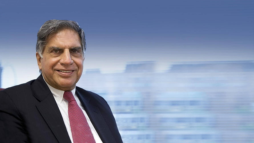 Ratan Tata Professional Portrait in Dark Suit and Red Tie Against Blurred City Skyline HD wallpaper