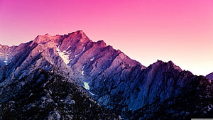 Vibrant Pink Sky Over Rugged Mountain Peaks at Sunset HD wallpaper