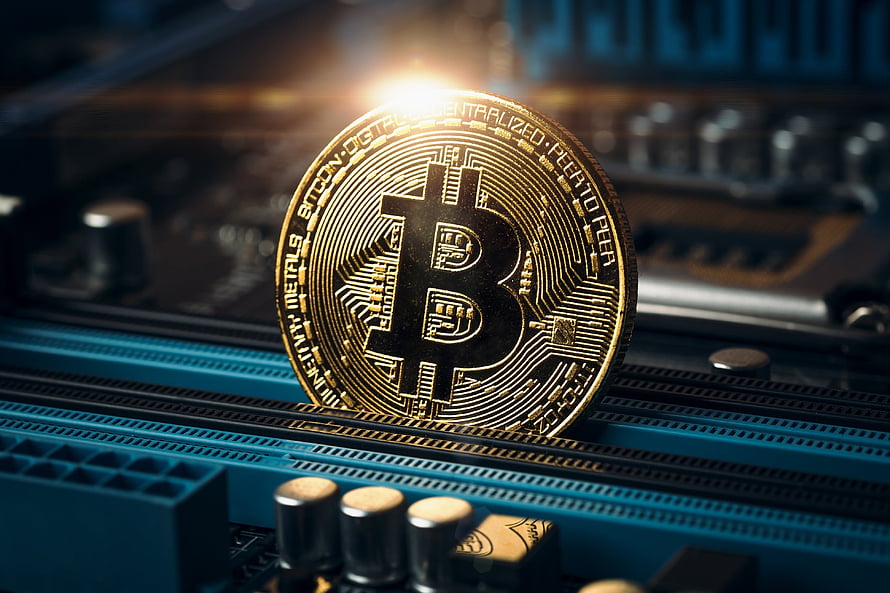 Golden Bitcoin Coin Resting on a Blue Circuit Board with Dramatic Lighting HD wallpaper