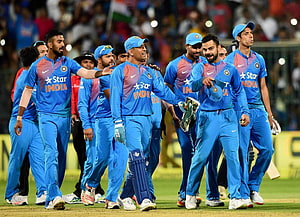 Indian Cricket Team Celebrating Victory in Blue Jerseys on the Field HD wallpaper