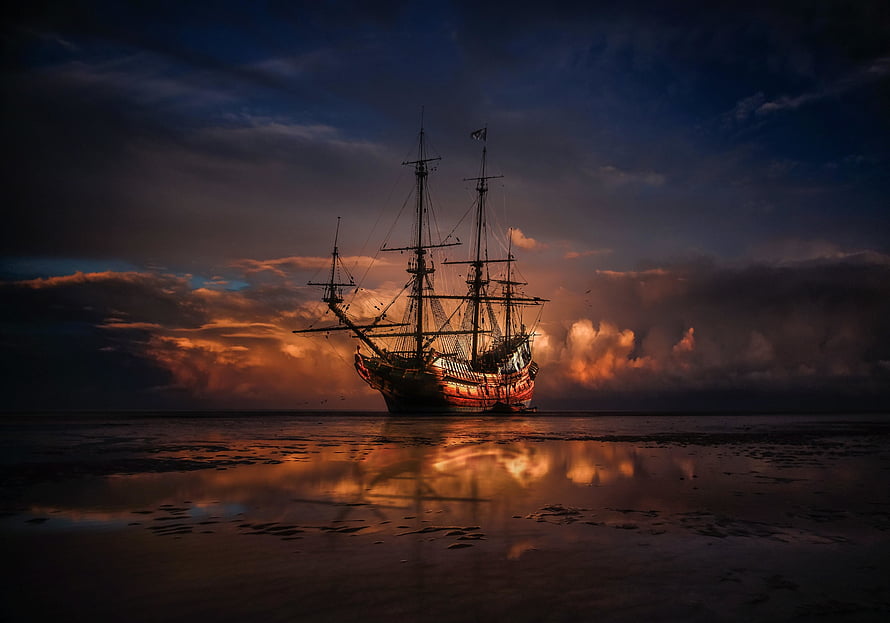 Silhouetted Tall Ship on Calm Waters at Golden Sunset HD wallpaper