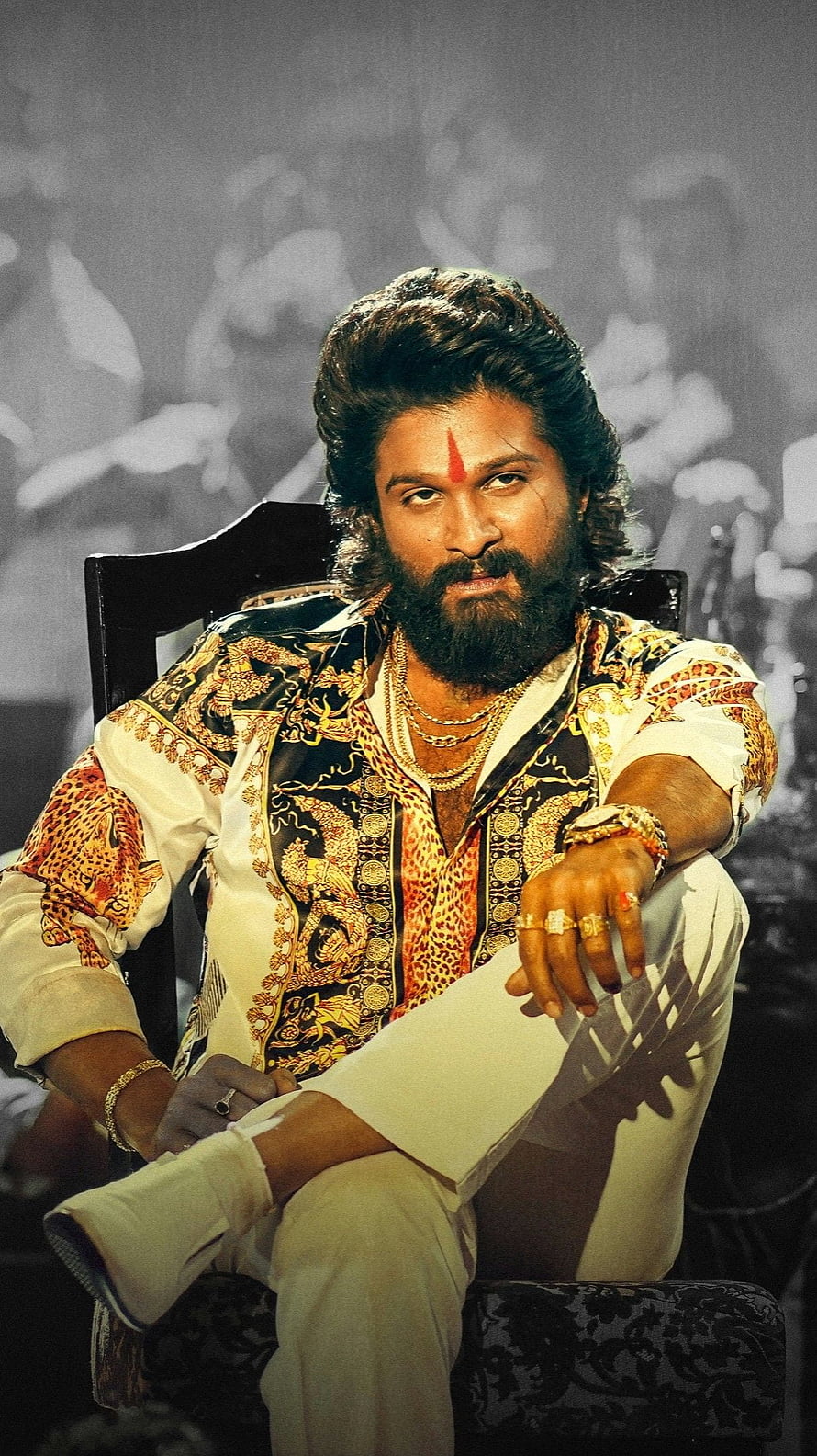 Allu Arjun in Pushpa 2 The Rule wearing a patterned shirt and gold jewelry sitting on a chair HD phone wallpaper