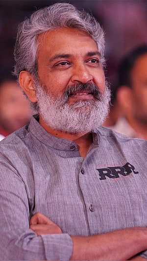 SS Rajamouli Portrait in Grey Band Collar Shirt with RRR Logo HD phone wallpaper