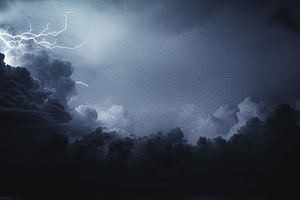 Dramatic Lightning Storm Illuminating Dark Clouds in a Thunderous Night Sky HD wallpaper