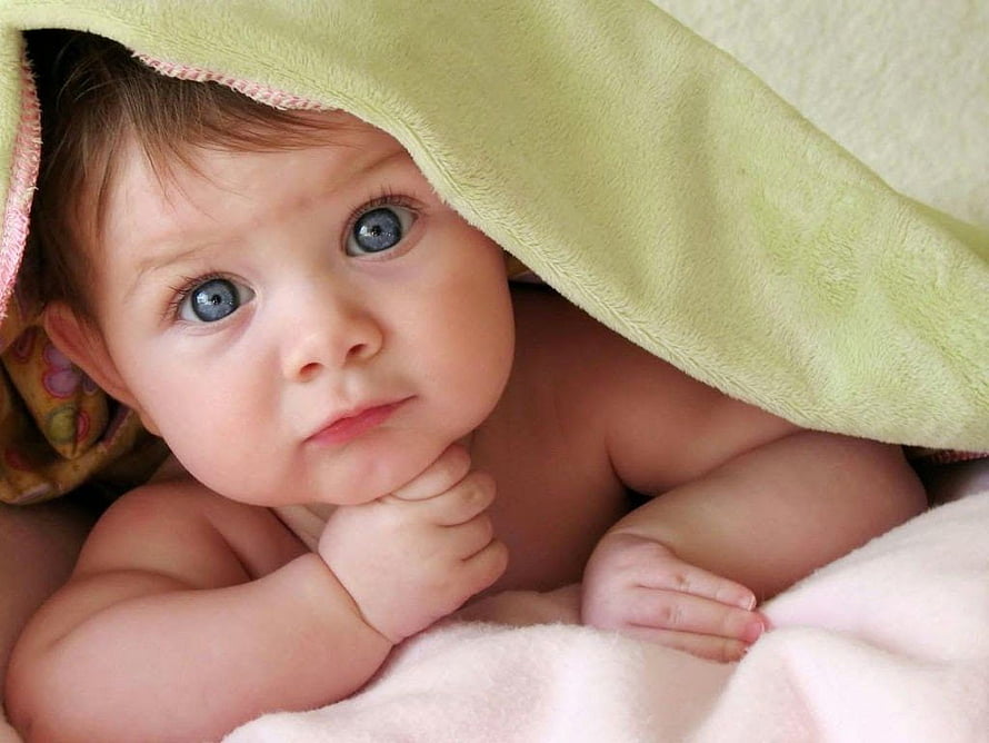 Cute Baby With Blue Eyes Peeking Out From Under A Soft Green Blanket HD wallpaper