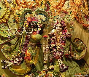Krishna and Radha Temple Statues Adorned with Fresh Flower Garlands and Ornate Jewelry HD wallpaper