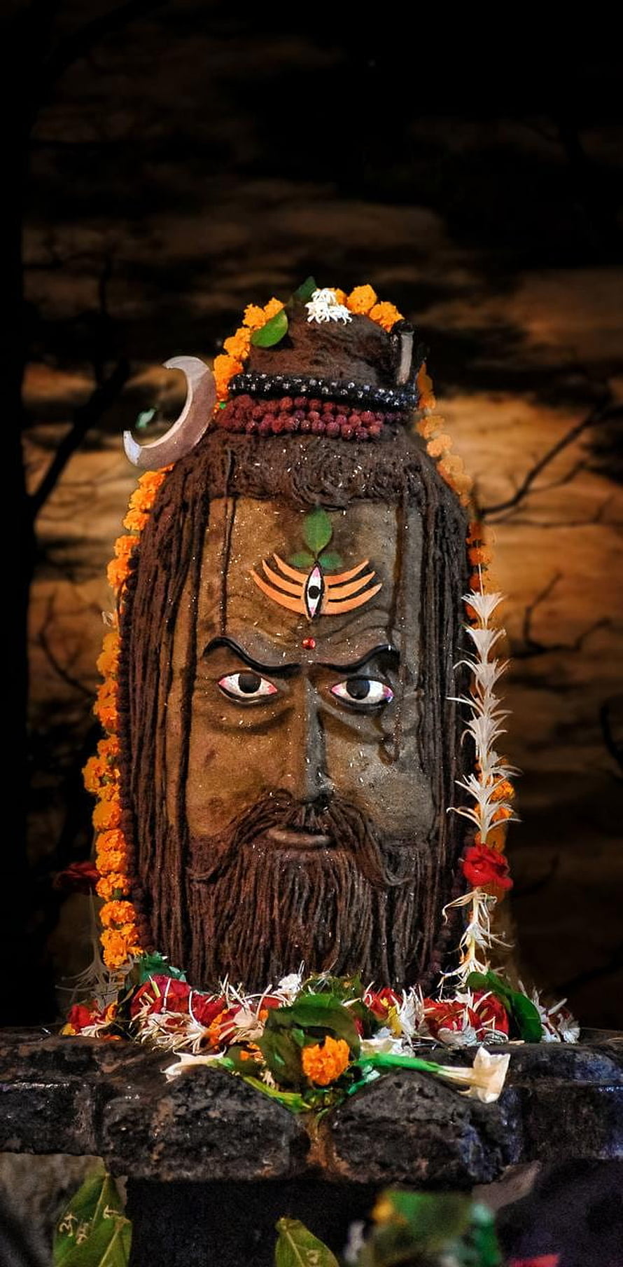 Decorated Shiva Lingam Statue With Crescent Moon And Marigold Flowers HD phone wallpaper
