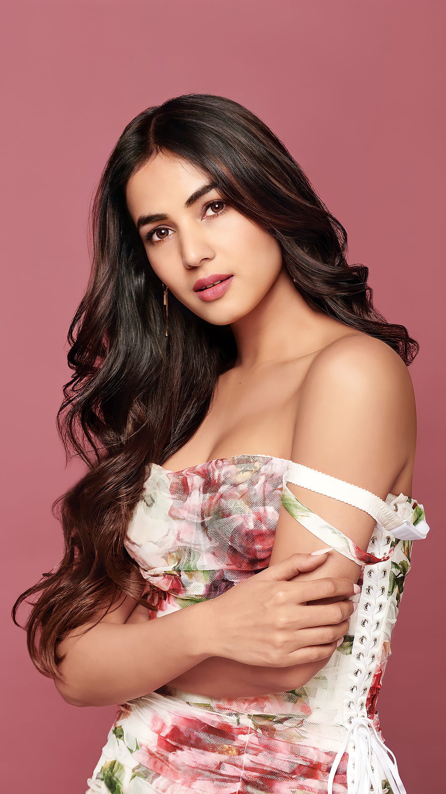 Sonal Chauhan in a floral off-shoulder dress against a pink studio backdrop HD phone wallpaper