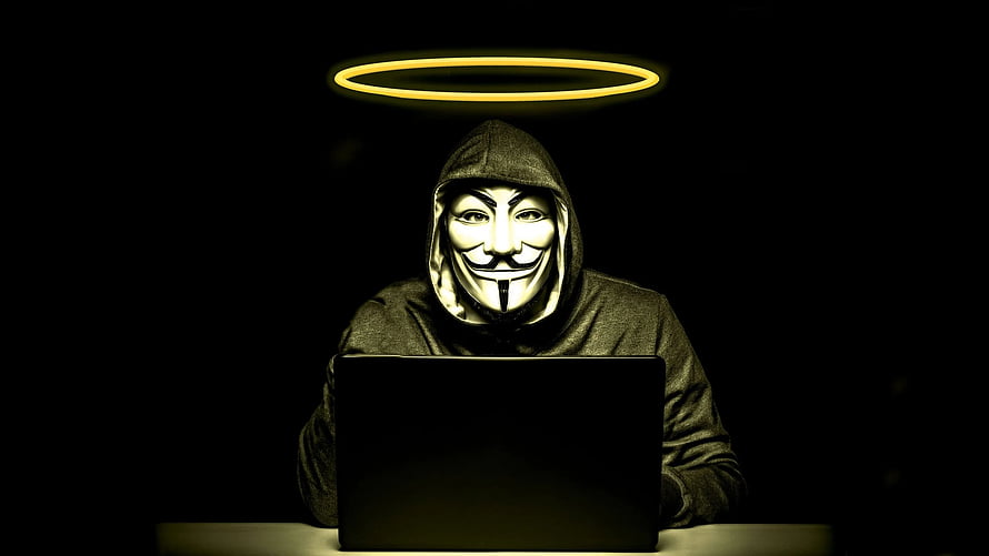 Anonymous Hacker With Halo Sitting At Laptop In Dark Room HD wallpaper