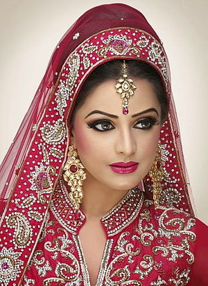 Elegant South Asian Bride in Deep Red Embroidered Lehenga with Gold Jewelry and Traditional Makeup HD phone wallpaper
