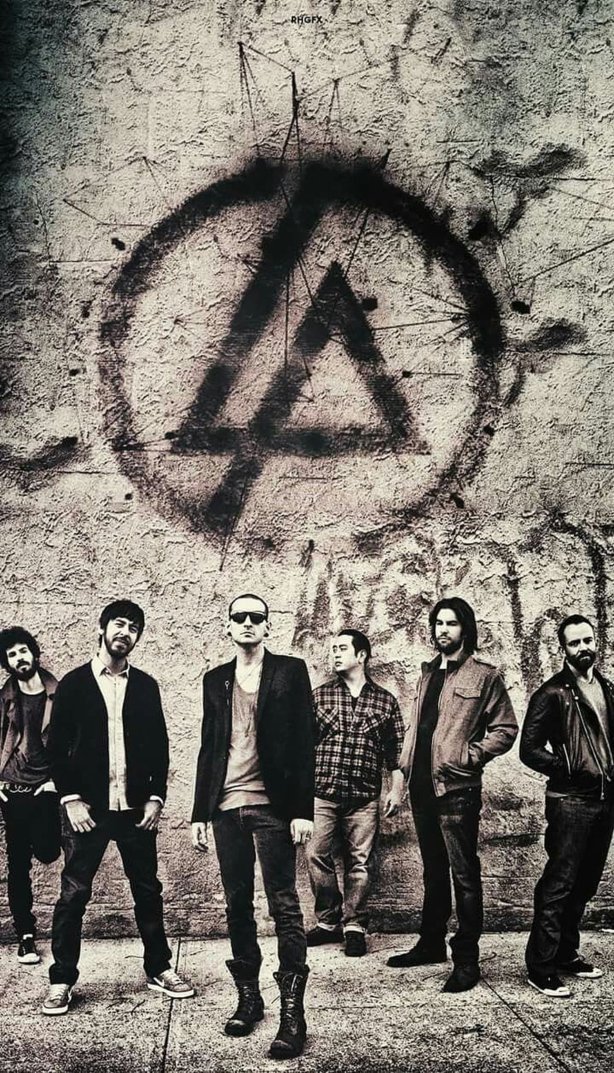 Linkin Park band members standing in front of a distressed wall with a large spray-painted logo HD phone wallpaper