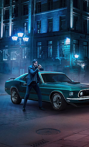 John Wick aiming pistol beside green Mustang in neon-lit city street HD phone wallpaper