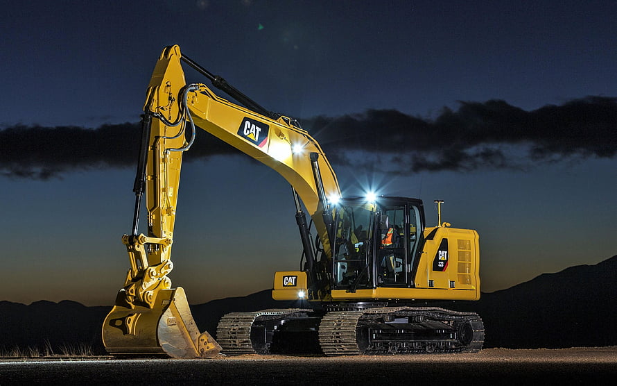 Caterpillar 323 Excavator Operating at Night with Bright Work Lights HD wallpaper