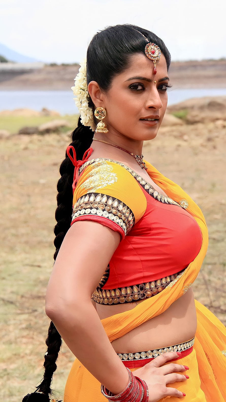 Varalakshmi in Traditional Yellow Saree with Gold Jewelry and Floral Hairpiece HD phone wallpaper