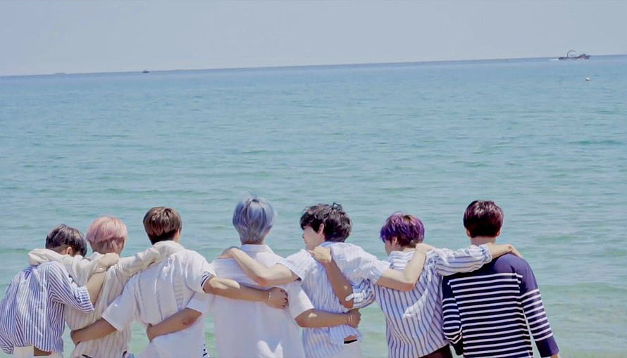 NCT Dream members standing together with arms around each other facing the ocean HD wallpaper