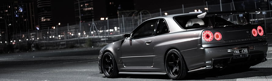 Modified Nissan Skyline GT-R R34 Night Scene with Carbon Fiber Body Kit and Rear Wing HD wallpaper