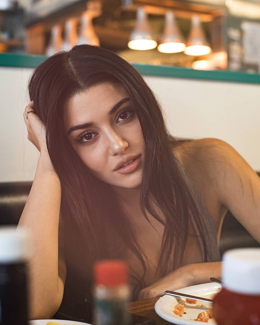 Hande Ercel Portrait in a Warmly Lit Restaurant Setting HD phone wallpaper