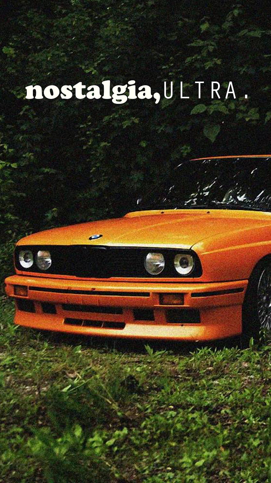 Classic Orange BMW M3 E30 Front View Parked on Grass with Nostalgic Text Overlay HD phone wallpaper