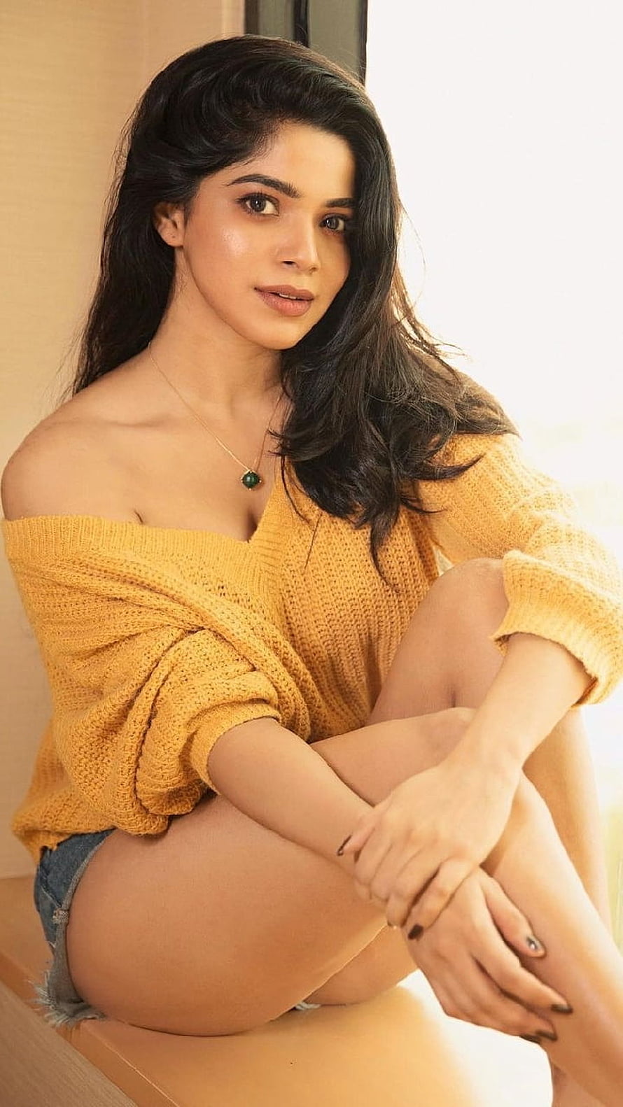 Divya Bharathi in a mustard yellow off-shoulder knit sweater and denim shorts HD phone wallpaper