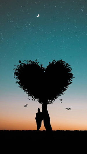 Silhouette of a person standing beneath a heart-shaped tree under a starry night sky with a crescent moon HD phone wallpaper