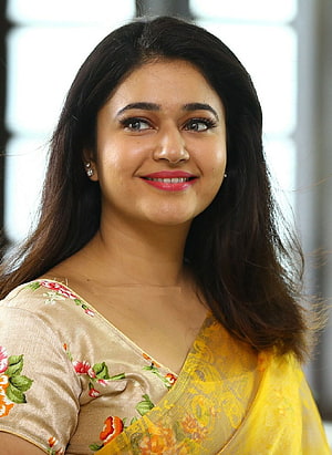 Poonam Bajwa in a Yellow Floral Saree with a Warm Smile HD phone wallpaper