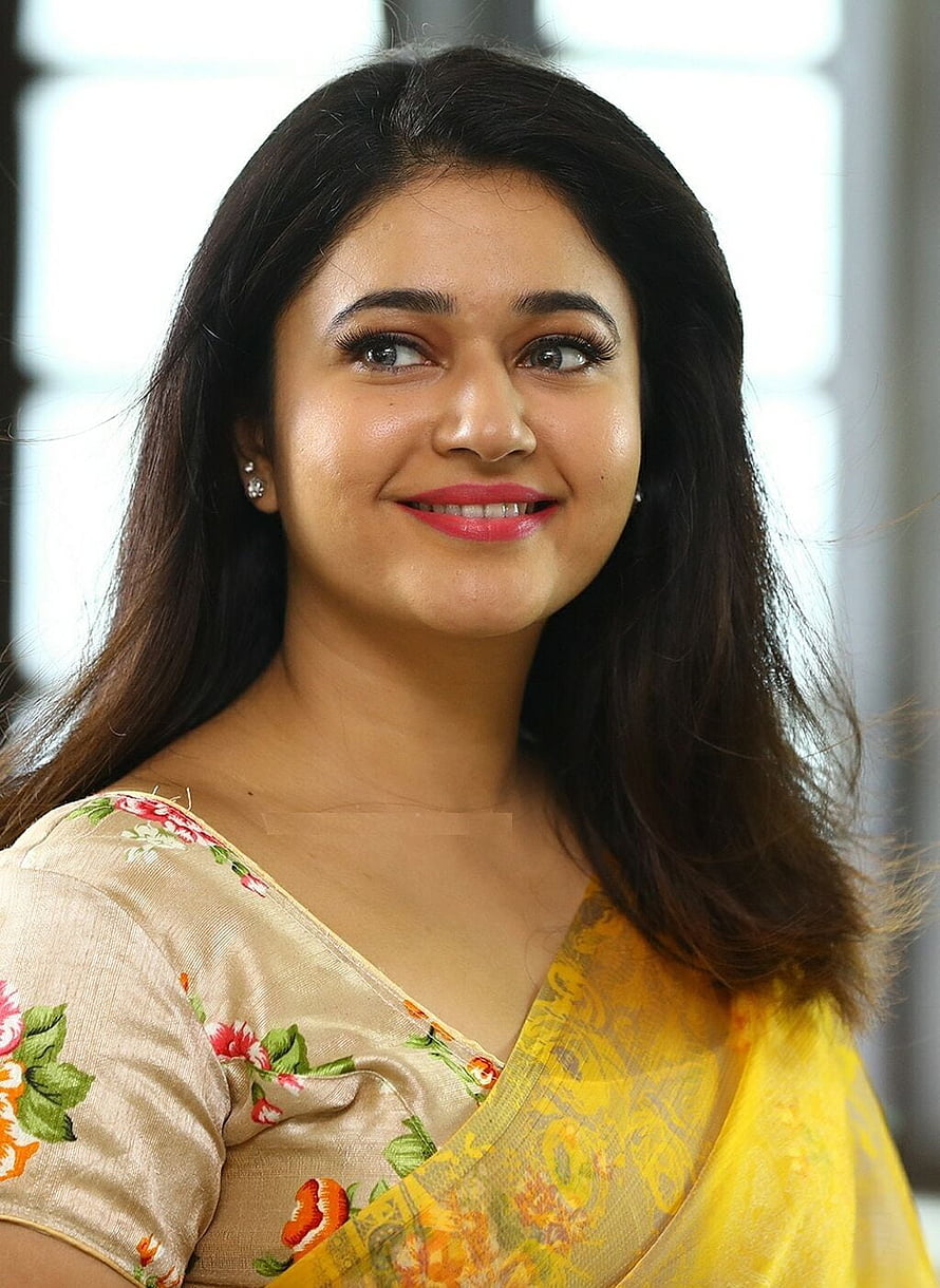 Poonam Bajwa in a Yellow Floral Saree with a Warm Smile HD phone wallpaper