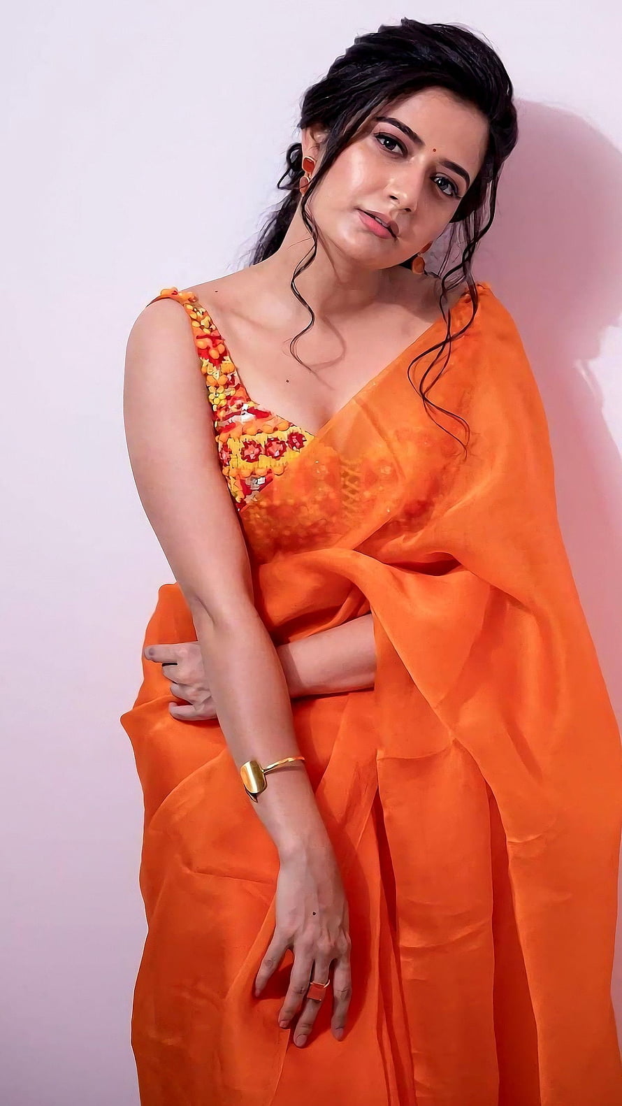 Ashika Ranganath in Vibrant Orange Saree with Floral Blouse HD phone wallpaper
