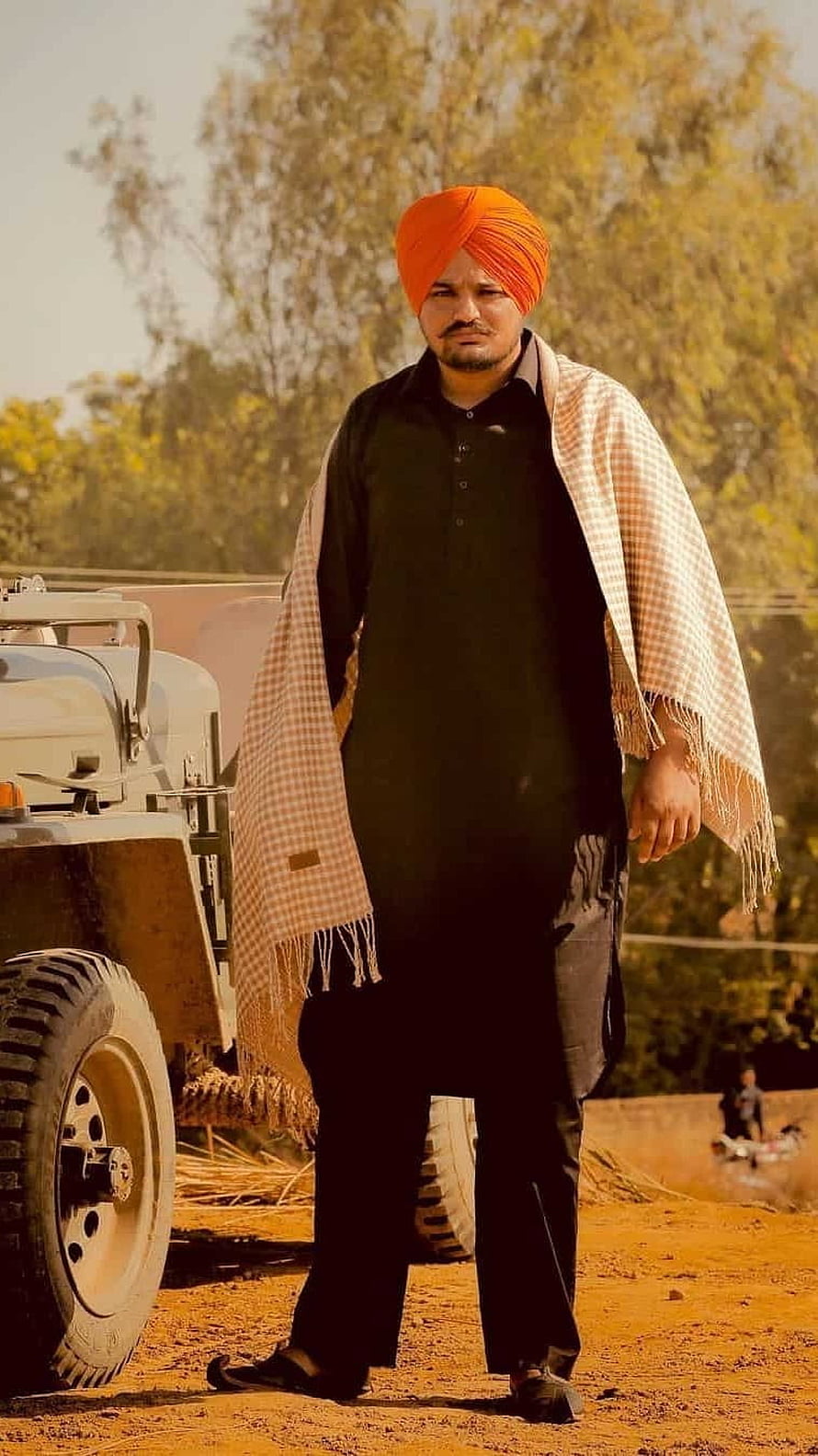 Portrait of a man wearing an orange turban and black kurta standing beside a tractor in a rural field, Sidhu Moose Wala, Village, Background HD phone wallpaper