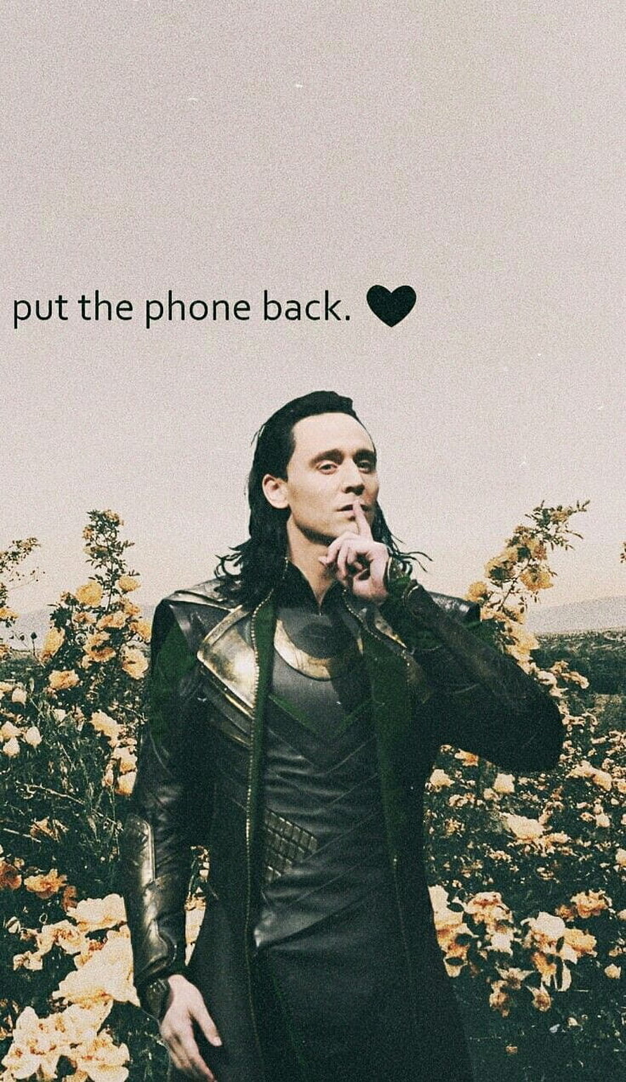 Loki by Tom Hiddleston in a field of yellow flowers with a shushing gesture HD phone wallpaper