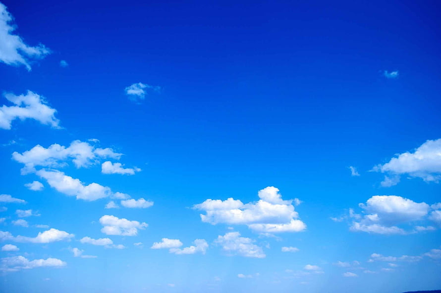 Serene Blue Sky With Fluffy White Clouds Scattered Across Bright Horizon HD wallpaper