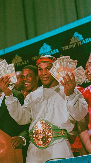 Mike Tyson holding cash and WBC championship belt at Trump Plaza boxing event HD phone wallpaper