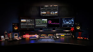 Professional Video Editing Studio Setup with Multiple Monitors and Audio Equipment HD wallpaper