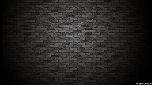 Dark Black Brick Wall Texture with Dramatic Vignette and Moody Industrial Atmosphere HD wallpaper
