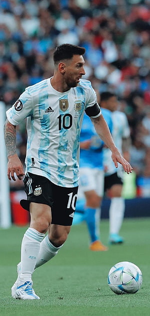 Lionel Messi in Argentina National Team Kit Dribbling Ball on the Pitch HD phone wallpaper
